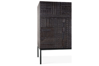 Ethnicraft Tabwa sideboard with dark hand-carved geometric wood panels and slim black metal legs, shown as premium designer furniture in Auckland.