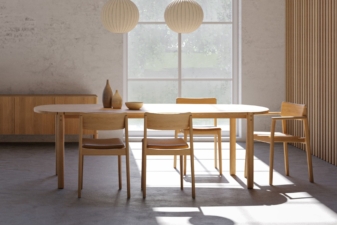 Modern dining room with an oval wooden table, minimalist chairs, and soft lighting.