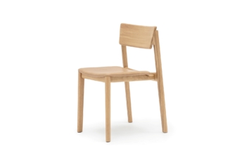 Side view of a minimalist wooden chair with a natural oak finish and a cushioned seat.
