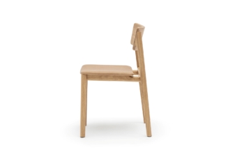 Side view of a minimalist wooden chair with a natural finish and a cushioned seat, showcasing sleek lines and contemporary design.