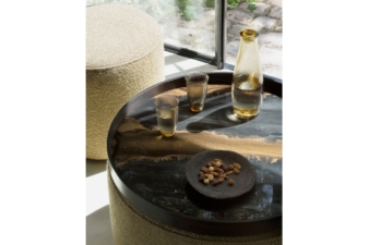 Round decorative tray table from Cuchi NZ with amber glass jug, tumblers, and nut bowl, modern furniture Auckland and home accessories.