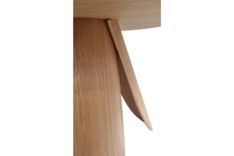 Close-up of sculptural curved wooden table legs showing seamless joinery and natural oak grain finish. wooden side tables nz, cuchi