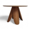 Stylish round wooden table featuring unique sculptural legs with a petal-like design, crafted in a warm natural oak finish for modern interiors. modern furniture cuchi nz