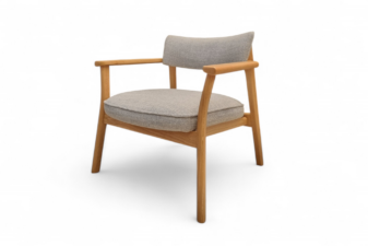 Side view of a stylish wooden armchair with a natural oak finish and soft grey fabric cushions.